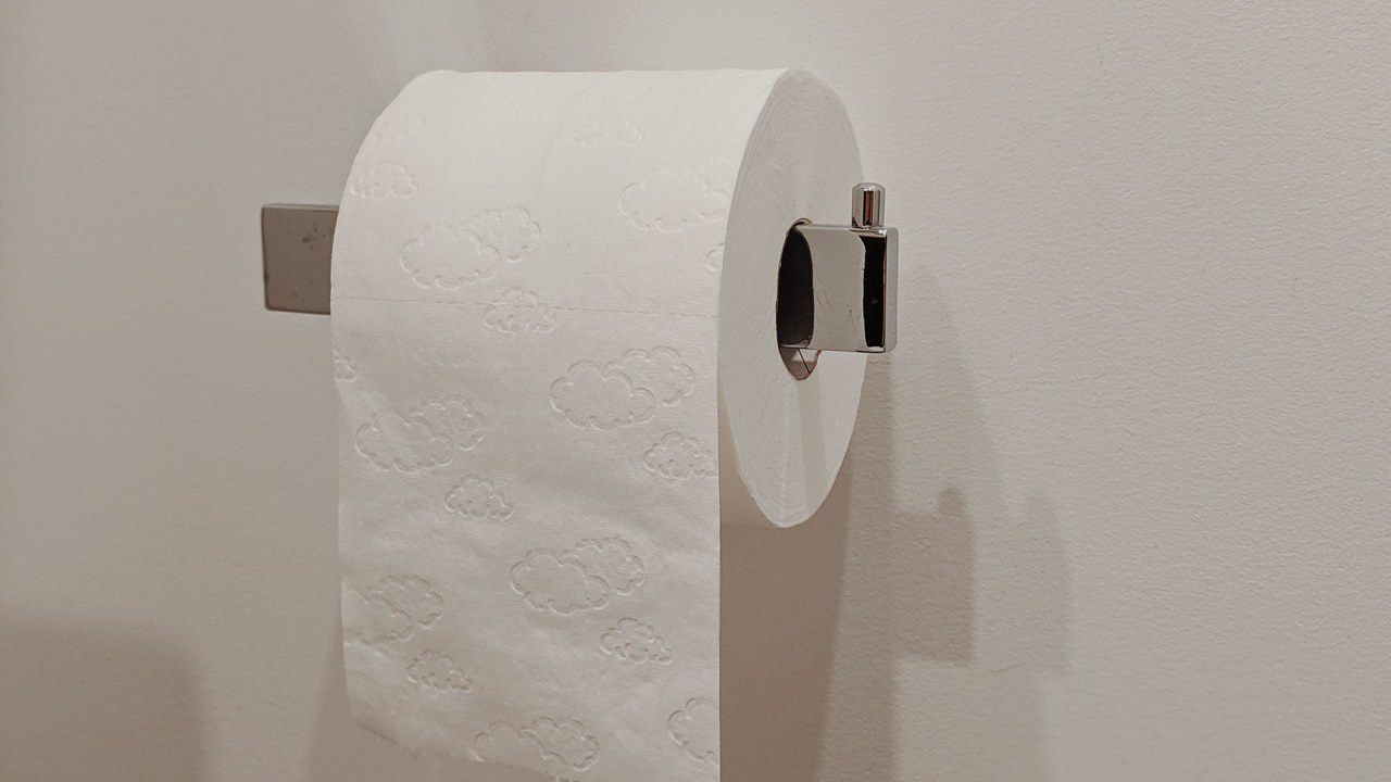 como poner el rollo de papel en el baño